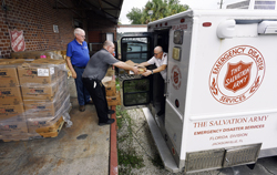 082817-(from left) Maintenance workers from the Salvation Army Carl Lundy and Daryl Hettick hand area commander Major Rob Vincent boxes of food as they stock the mobile kitchen for the trip to Texas Monday afternoon. Staff from the Salvation Army in Jacksonville, Florida loaded their mobile kitchen with food and supplies Monday afternoon, August 28, 2017 at their Davis Street facility as they prepared for the long trip to Texas to help provide aid in the wake of Hurricane Harvey. According to Major Rob Vincent, The Salvation Army Area Commander a team of two will drive to Pensacola Tuesday starting at 7:30 am and meet up with seven other teams and spend the night. The next day they will all drive to the Dallas, TX Salvation Army warehouse where they will be assigned to various sites. The local team is told to prepare for a 14 day deployment. (AP Photo/Bob Self/Florida Times-Union)